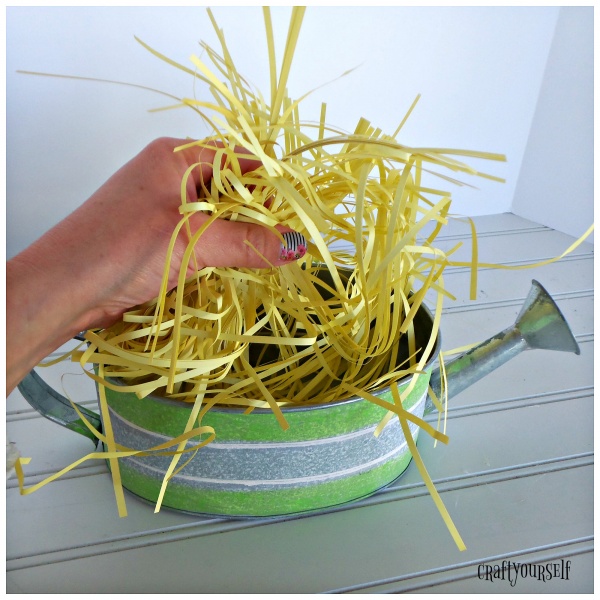 watering can fill basket with grass